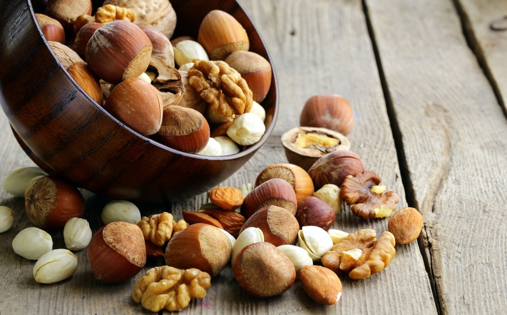 Mix nuts (almonds, hazelnuts, walnuts) on a wooden table