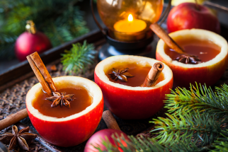 Colorful holiday cocktails in carved out apples.